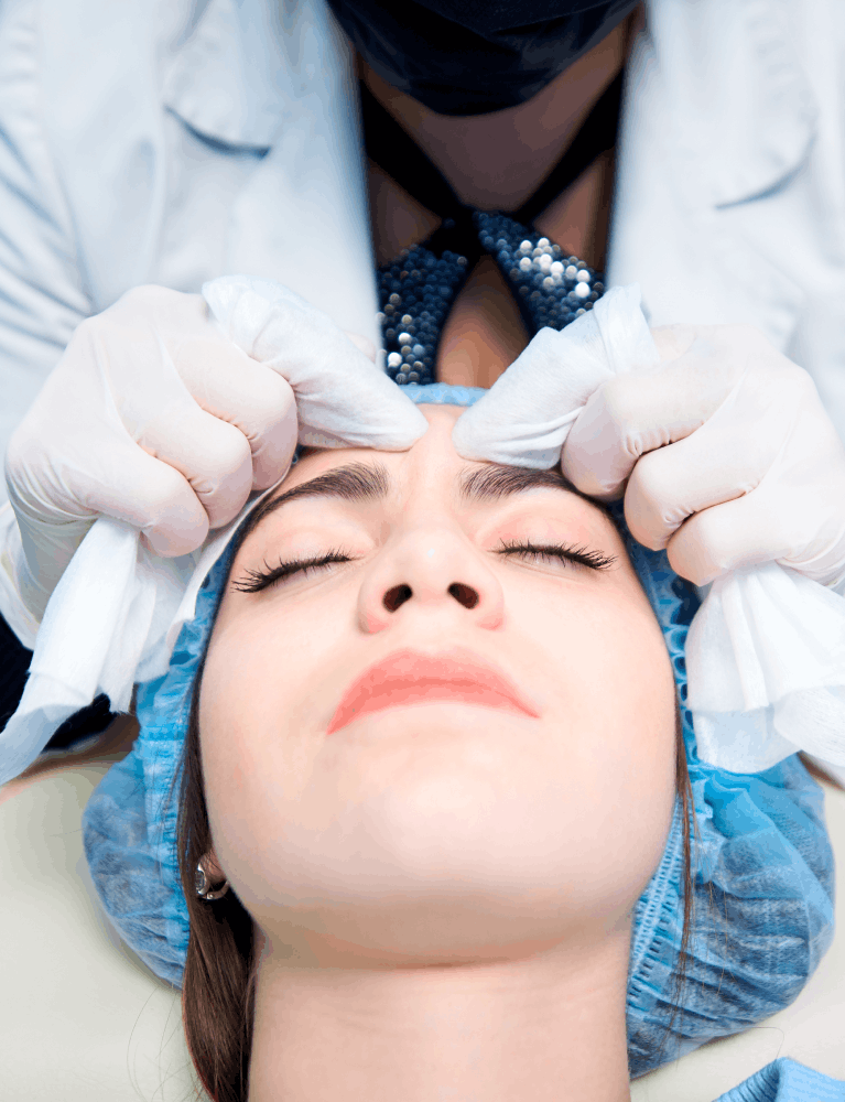 Dermatologist performing DPN removal treatment on a patient at a skin clinic in Chennai.