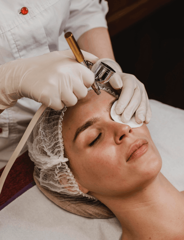 Dermatologist performing a glass skin facial treatment on a patient at a skin clinic in Chennai.
